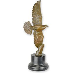 A BRONZE SCULPTURE OF A PIGEON IN A FLIGHT