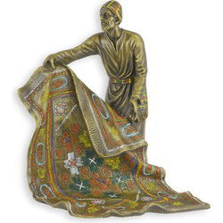 A BRONZE SCULPTURE OF AN ARAB CARPET SELLER