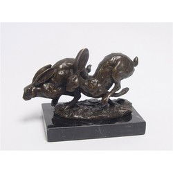 A BRONZE SCULPTURE OF TWO RUNNING HARES