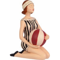 A RESIN FIGURINE OF A LADY WITH BEACHBALL