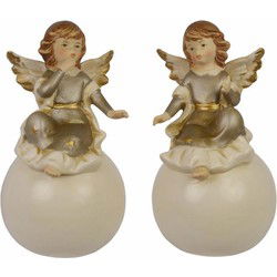 A PAIR OF PORCELAIN ANGELS ON BALL
