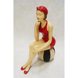 A RESIN FIGURINE OF A LADY IN SWIMSUIT