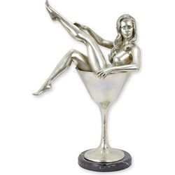 A BRONZE SCULPTURE OF A WOMAN IN A COCKTAIL GLASS