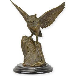 A BRONZE SCULPTURE OF AN OWL WITH WINGS WIDE