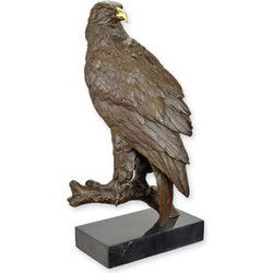 A BRONZE SCULPTURE OF AN EAGLE AT REST