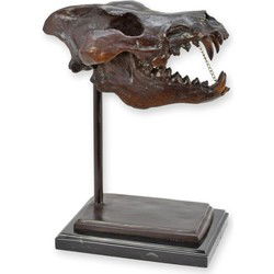 A BRONZE SCULPTURE OF A DIRE WOLF SKULL ON A MARBLE BASE