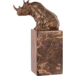 A BRONZE SCULPTURE OF A SITTING RHINOCEROS