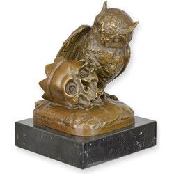 A BRONZE SCULPTURE OF AN OWL WITH A SKULL