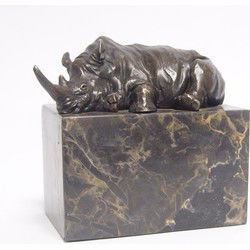 A BRONZE SCULPTURE OF A LYING RHINOCEROS
